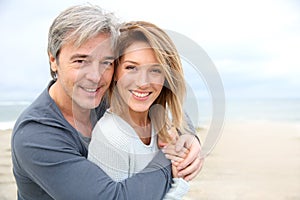 Cheerful mature couple on the beach