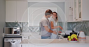 Cheerful mature couple hugging flirting in kitchen having romantic relationship. wife and husband embrace share intimate