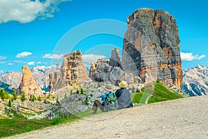 Cheerful mature couple sitting in mountains and enjoying the view