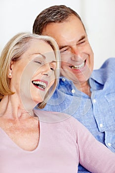 Cheerful mature couple together having fun against white. Closeup portrait of a cheerful mature couple together having