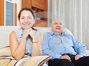 Cheerful mature woman against elderly man