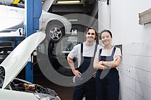 Cheerful mechanic in uniform looking at