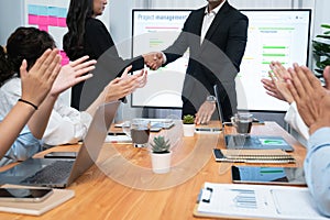 Cheerful meeting room, businesspeople celebrate in meeting room. Habiliment