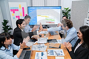 Cheerful meeting room, businesspeople celebrate in meeting room. Habiliment