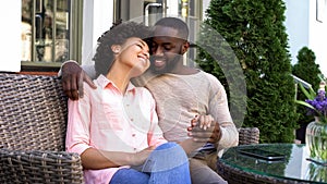 Cheerful man and woman enjoying romantic date, sitting at cafe, relationship photo