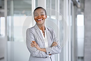 Cheerful mid adult business woman smiling at office