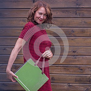 Cheerful middle age woman with a gift.