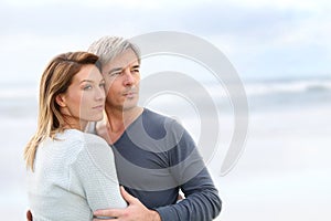 Cheerful middle-aged couple by the beach