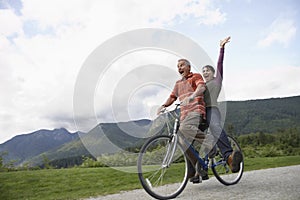 Cheerful Middle aged Couple Bicycling On Country Road