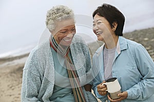 Cheerful Middle Aged Female Friends On Beach