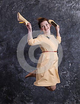 Cheerful middle aged woman dressed in beige dress studio portrait.