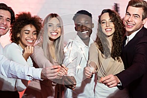 Cheerful Millennials Holding Burning Sparklers Having Party Indoor