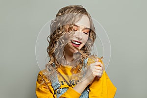 Cheerful model girl smiling on gray background