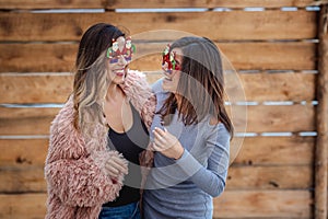 Cheerful mom and her daughter celebrate New Year party