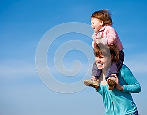 Cheerful mother and curly baby girl