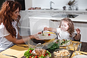 Cheerful mother and daughter having lunch together