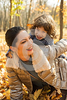 Cheerful mother and son having fun in park