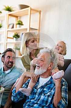 Cheerful multi-generation family having fun while spending time together at home.