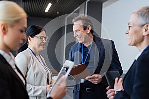 Cheerful multiethnic business people with coffee