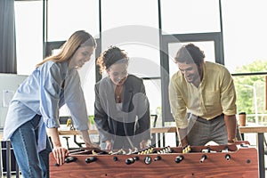 Cheerful multiethnic business people playing table