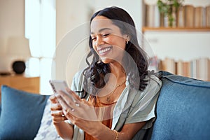 Cheerful multiethnic woman messaging on phone