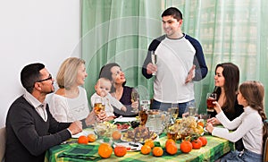 Cheerful multigenerational family sitting at holiday table