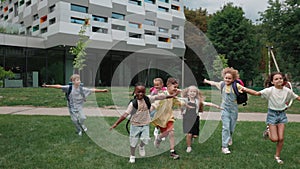 Cheerful multiracial children taking fun on schoolyard