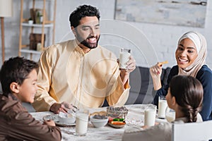 Cheerful muslim family having suhur breakfast photo