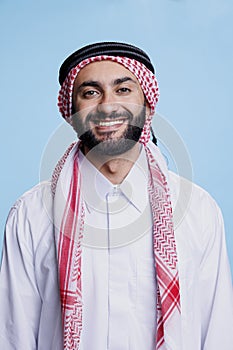 Cheerful muslim man studio portrait