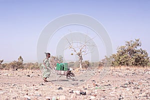 Cheerful Native African Infant Working with Clean Water in Bamako