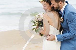 Cheerful newlyweds at beach wedding ceremony