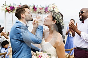 Cheerful newlyweds at beach wedding ceremony