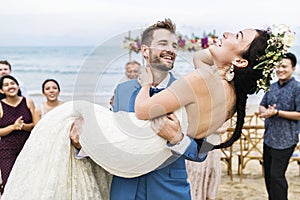 Cheerful newlyweds at beach wedding ceremony