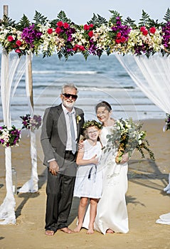 Cheerful newlyweds at beach wedding ceremony