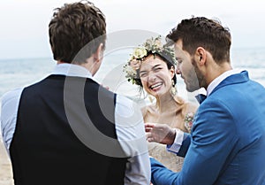 Cheerful newlyweds at beach wedding ceremony