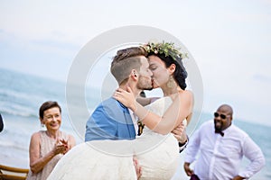 Cheerful newlyweds at beach wedding ceremony