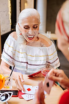 Cheerful nice woman sitting at the table