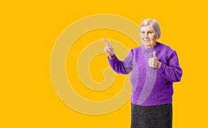 Cheerful octogenarian woman showing on empty place for copy space.