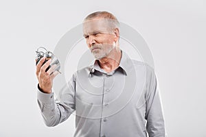 Cheerful office worker holding the clock