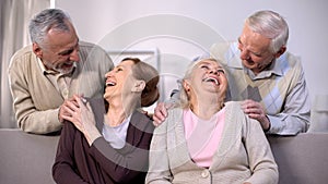 Cheerful old couples laughing and having fun together sitting home, friendship