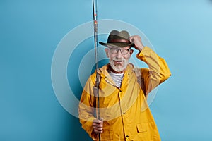 Cheerful old man has noticed a big fish in the lake