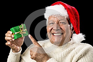 Cheerful Old Man Pointing At Green Wrapped Gift