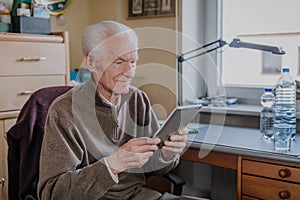 Positive Senior using Digital Tablet