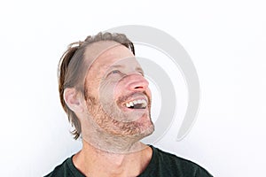 Cheerful older man laughing and looking up