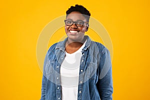 Cheerful Overweight African American Lady Posing Over Yellow Background