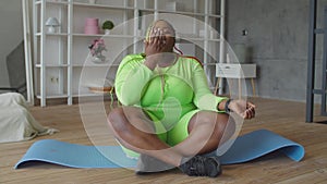 Cheerful overweight woman showing heart shape