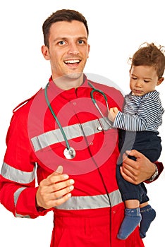 Cheerful paramedic holding baby