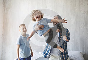 Cheerful parent playing with boys