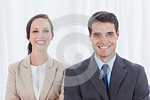 Cheerful partners posing together looking at camera