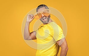 cheerful party man in summer glasses  on yellow. party man in summer glasses